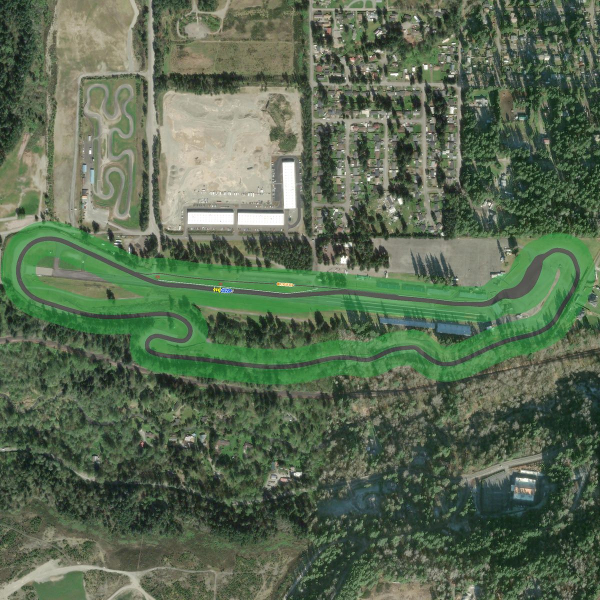 Top-down preview of Pacific Raceways Road Course with the generated road, kerbs and grid overlaid on satellite imagery